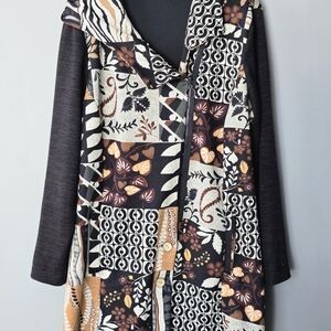 Long-sleeve, hooded asymmetrical zip-up jacket.  Patchwork design.